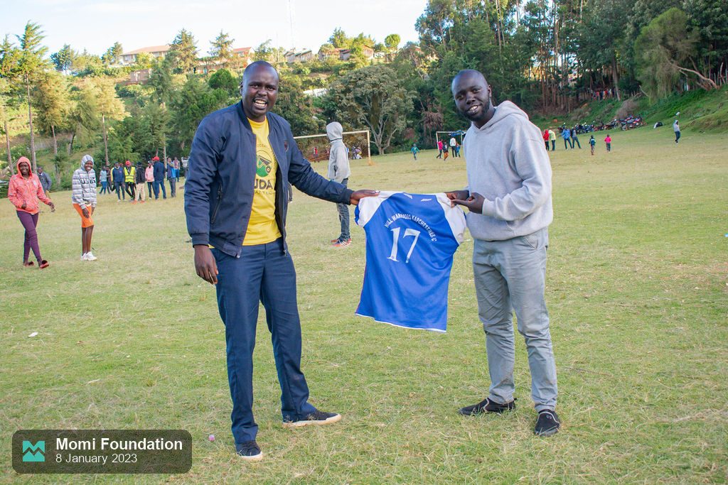 A football jersey being presented on the pitch