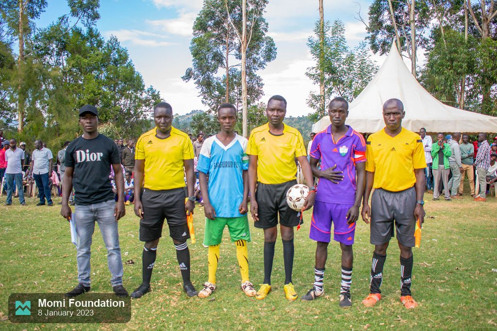 Referees and team captains standing together before a match
