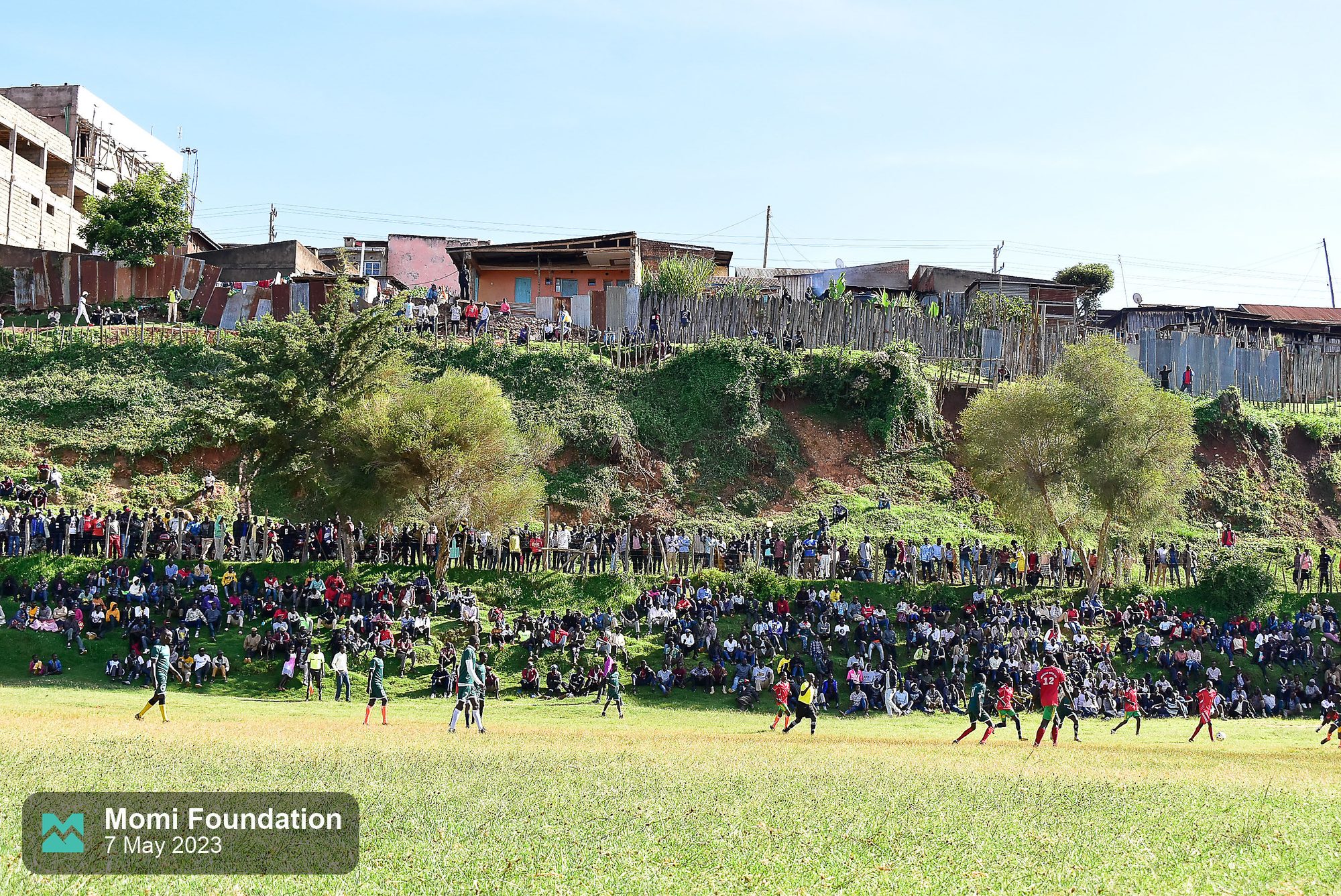 Fans watching from the hillside above the pitch