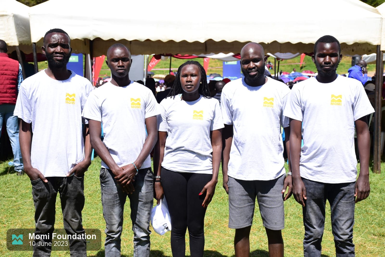 The Momi Foundation team standing together in white event T-shirts