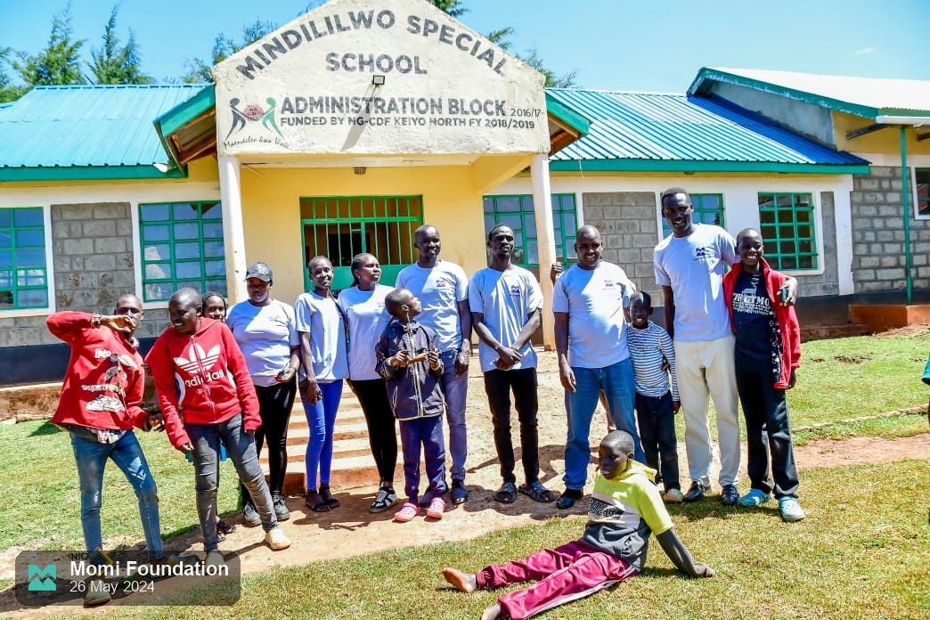 The Momi Foundation team with pupils in front of the Mindililwo Special School administration block