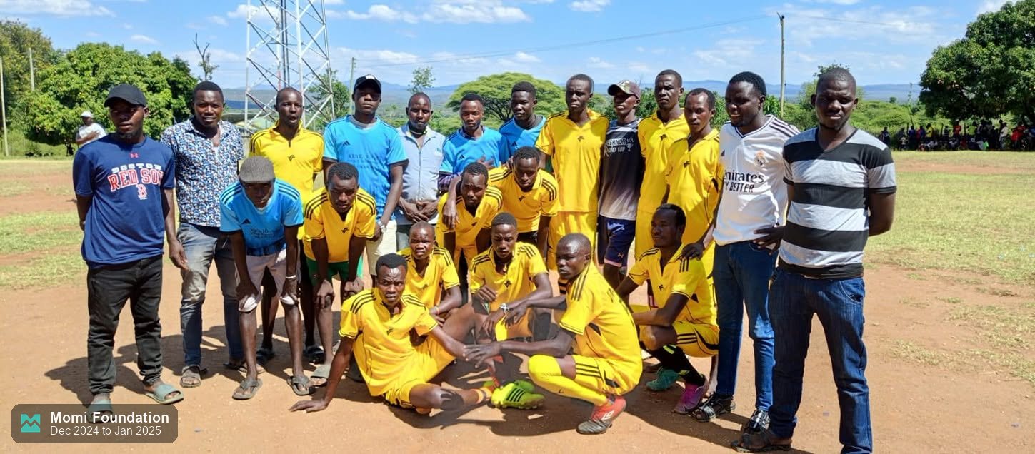 Kirbei FC players in yellow posing for a team photo